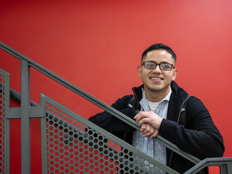 Adult learner standing on stairs in Gaige Building